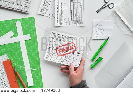 Fake Covid Vaccination Record Card. Covid Scams. Forged Health Certificate With False Vaccination Re