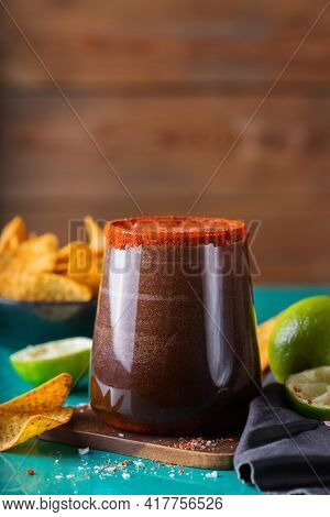 Mexican Alcohol Cocktail Michelada With Dark Beer And Lime Juice