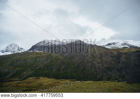 Minimalist Alpine Landscape With Snowy Mountains In Low Cloud In Overcast Weather. Deep Gorge On Bac