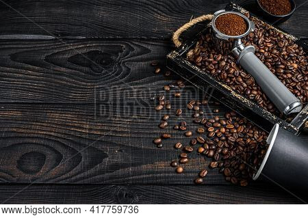 Ground Coffee In Portafilter For Espresso In A Wooden Tray With Coffee Beans. Black Wooden Backgroun