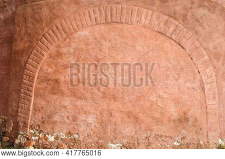 Red wall background, Closeup photo of grunge red wall with brick arch of Saint Euthymius monastery in Suzdal, Russian architecture detail