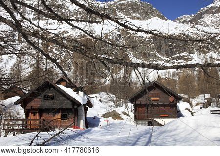Devero Park ( Verbano-cusio-ossola ), Italy - January 15, 2017: Typical Houses In The Forest At Alpe