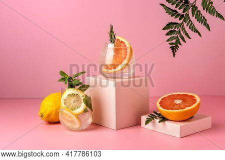 Two Hard Seltzer Cocktails With Grapefruit And Lemon. Refreshing Colorful Summer Drinks On Pink Back
