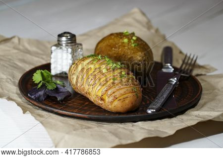 Baked Potatoes In The Skin On A Plate