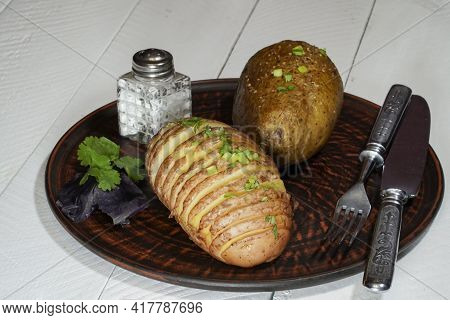 Baked Potatoes In The Skin On A Plate