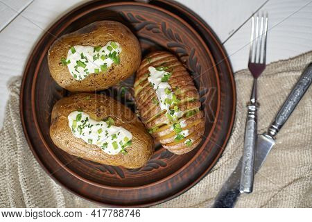 Baked Potatoes In The Skin On A Plate