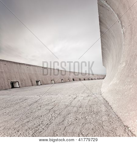 Concrete Dike Or Dam Structure, Wall And Floor, Cloudy Sky.
