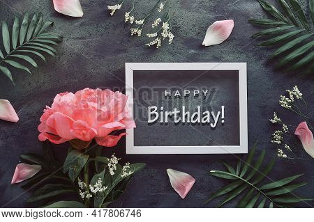Happy Birthday Card With Peony And Palm Leaves. Flowers, Petals And Exotic Leaves Around White Frame