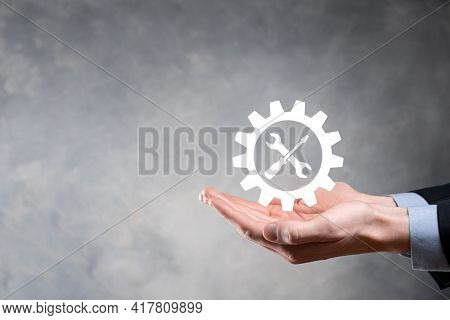 Businessman Holding Gear Icon With Tools.gearing.concept Of Target Focus Digital Diagram,graph Inter
