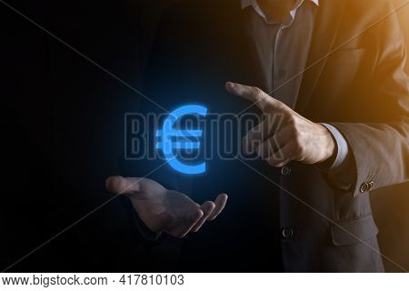 Businessman Holds Money Coin Icons Eur Or Euro On Dark Tone Background..growing Money Concept For Bu