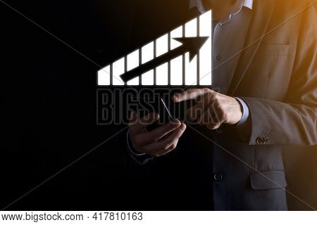 Business Man Holding Holographic Graphs And Stock Market Statistics Gain Profits. Concept Of Growth