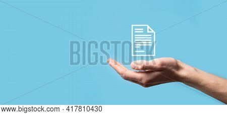 Male Hand Holding A Document Icon On Blue Background. Document Management Data System Business Inter
