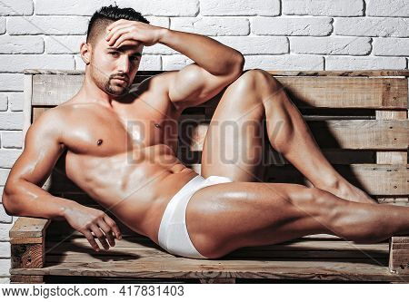 Sexy Muscular Men With Bare Naked Body Torso In Underpants On Wooden Pallet Sofa.