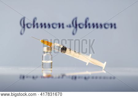 Johnson And Johnson Coronavirus Vaccine Vial And Syringe With Logo As Background. Ljubljana, Sloveni