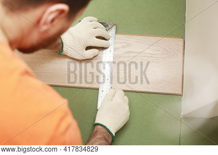 Installation Laminate Or Parquet In The Room, Worker Installing Wooden Laminate Flooring, Marking Th