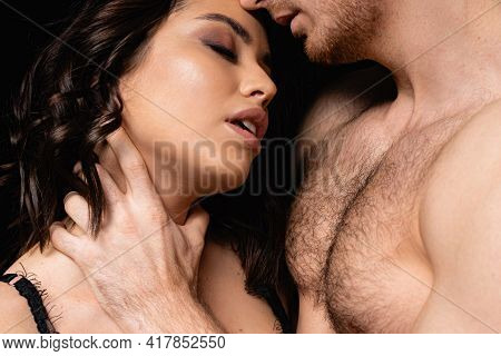 Shirtless Man Choking Sexy Woman Isolated On Black.