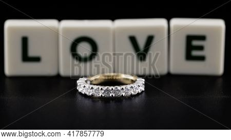 A Diamond Eternity Ring, Also Known As An Infinity Ring, Symbolizing Never Ending Love, On Black Bac
