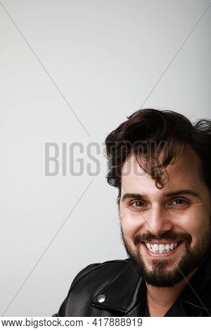 Vertical Portrait Of Handsome Biker Man Wearing Leather Jacker Posing Over White Background. Space F