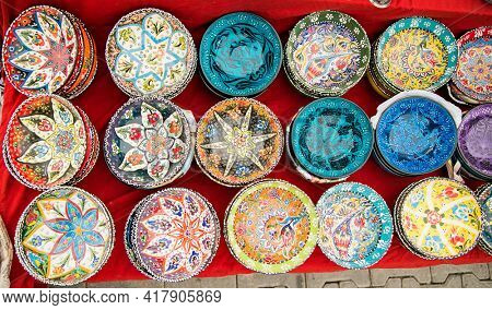Alanya , Turkey- October 20, 2020: Turkish ceramics, painted plates with a souvenir shop  on the street market in Alanya, Turkey.
