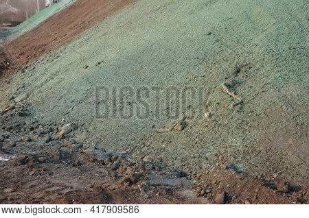 Stabilization Of Slopes By Hydro Sowing. A Mixture Of Wood Pulp And Green Grass Seed Is Sprayed From