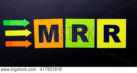 Bright Multi-colored Paper Stickers On A Black Background With The Text Mrr