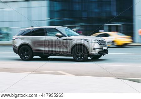 Moscow , Russia - April 2021: Beige Offroad Car Range Rover Velar Rides In The City Street With Moti