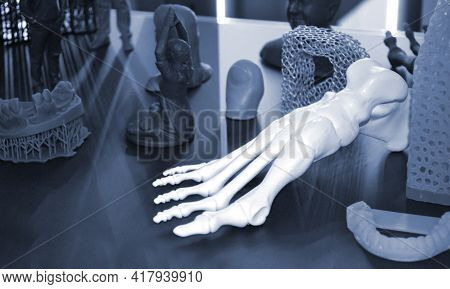 White Prototype Of The Human Foot Skeleton Printed On 3d Printer On Dark Surface.