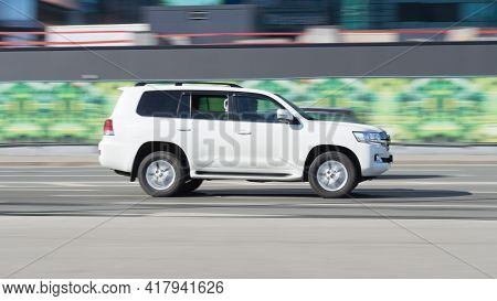 Toyota Land Cruiser 200 Rides On The Road. White Premium Suv On The City Street In Motion. Moscow, R