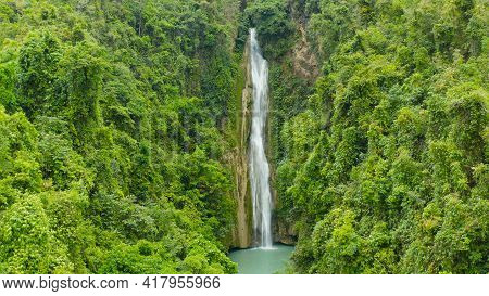 Beautiful Waterfall In Green Forest, Top View. Tropical Mantayupan Falls In Mountain Jungle, Philipp