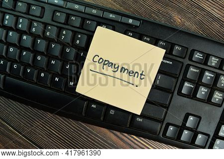 Copayment Write On Sticky Notes Isolated On Wooden Table.
