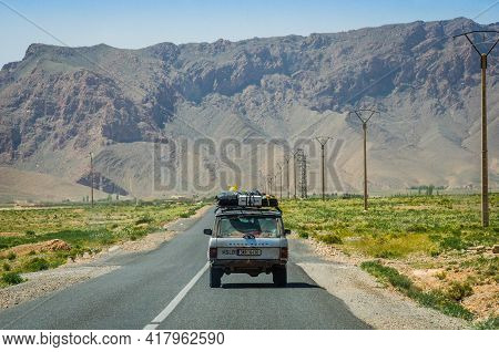 Midelt, Morocco - April 11, 2015. Fully Loaded Vintage Off Road Car Going On The Tar Road And Headin
