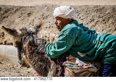 Midelt, Morocco - April 11, 2015. Old Handicapped Man Moving On The Donkey And Begging For Money