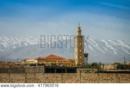Minaret Of Mosque In Midelt With Atlas Mountain In Background In Morocco