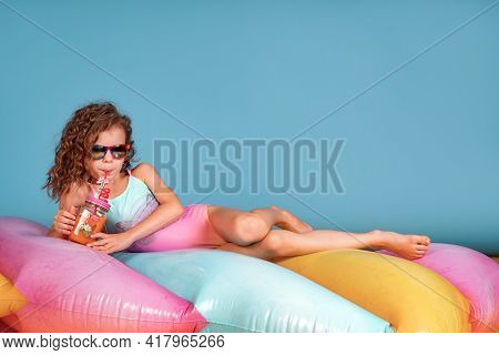 Beautiful Girl In Colorful Swimsuit And Sunglasses Holding Pinea