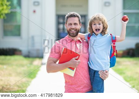 Portrait Of Happy Father And Son Come Back From School.