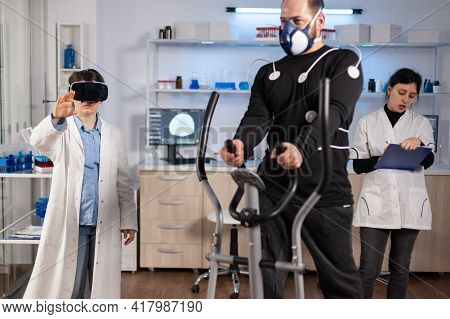 Scientist Doctor In Sport Science Laboratory Wearing Virtual Reality Goggles