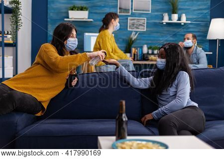 Group Of Multi Ethnic People Using Hand Sanitizer Gel