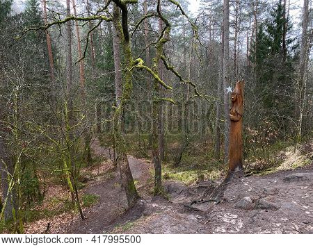 Wooden Sculpture of a fairy at the edge of the fairy path in Virton, Luxembourg, Belgium