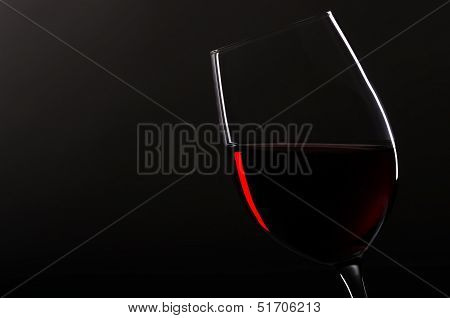 Wineglass With Redwine Before Black Background