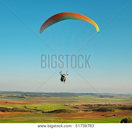 paraglider is flying over Spain