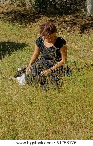 Woman In An Autumn Garden