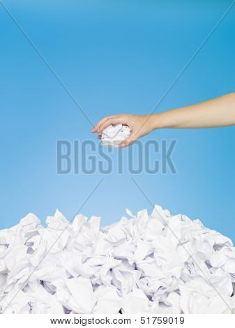 Human trowing away a paper on the stack