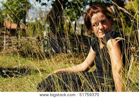 Woman In An Autumn Garden