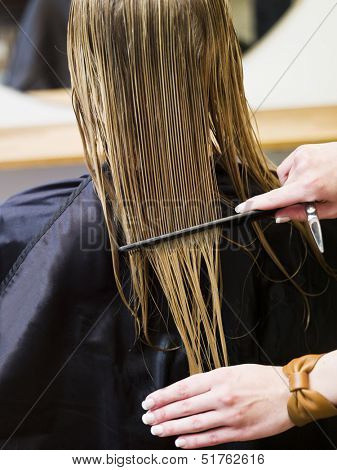 Combing at the hair saloon close up