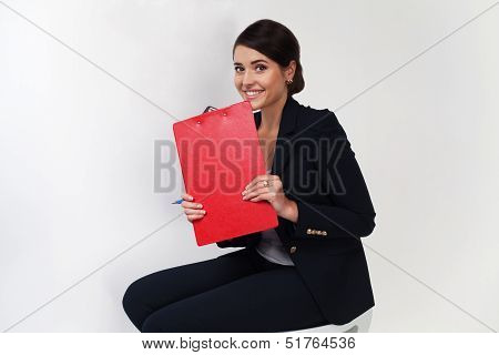 Beautiful business girl in black suit smiling with red portfolio