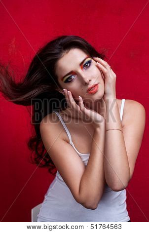 Portrait of a beautiful girl with colorful eyemakeup in white shirt