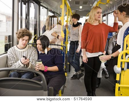 Couple going by bus with large group of people