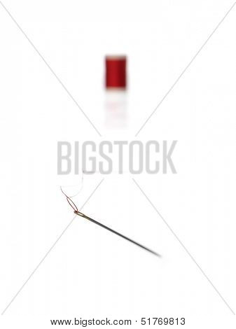 Thread Reel and nedle on white background