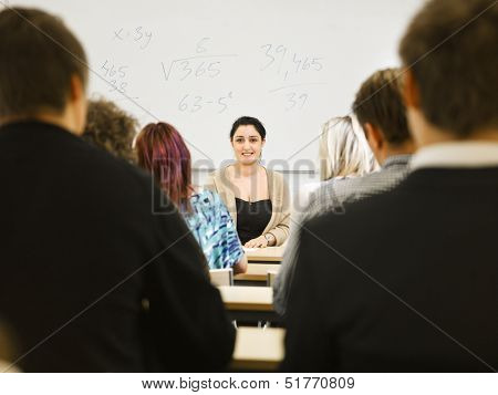 Schoolteacher in front of pupils in the classroom