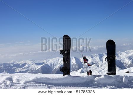 Three Snowboards In Snow Near Off-piste Slope In Sun Day